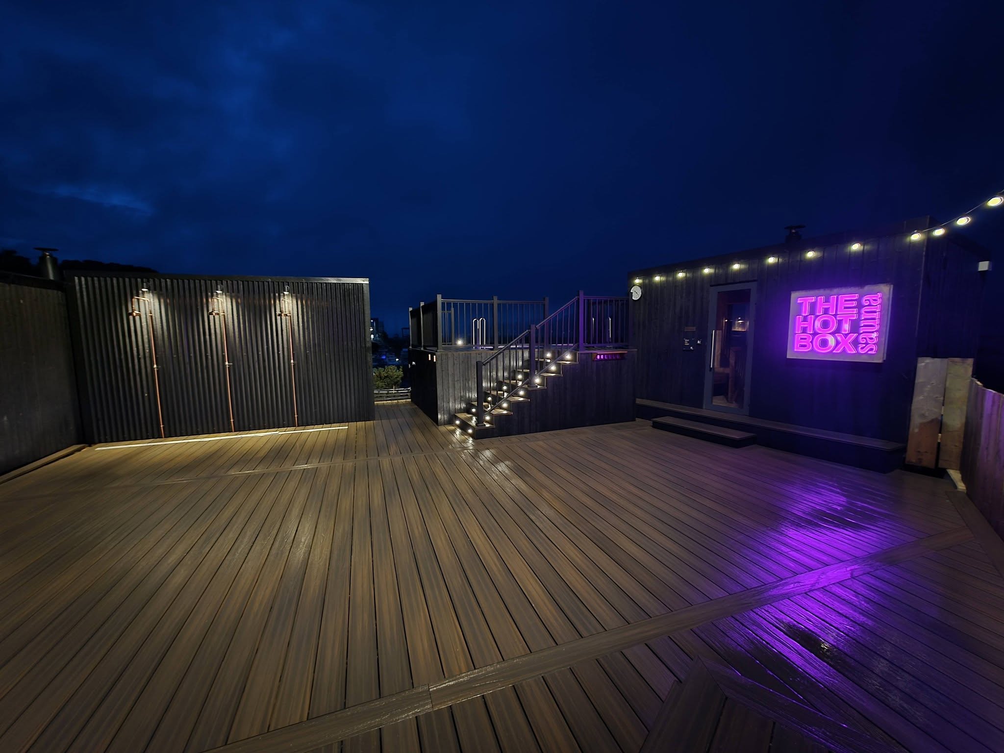 Wide composite deck with festoon lighting at night